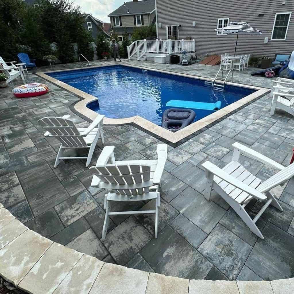 Backyard in-ground pool with gray paver patio Backyard in-ground pool with gray paver patio